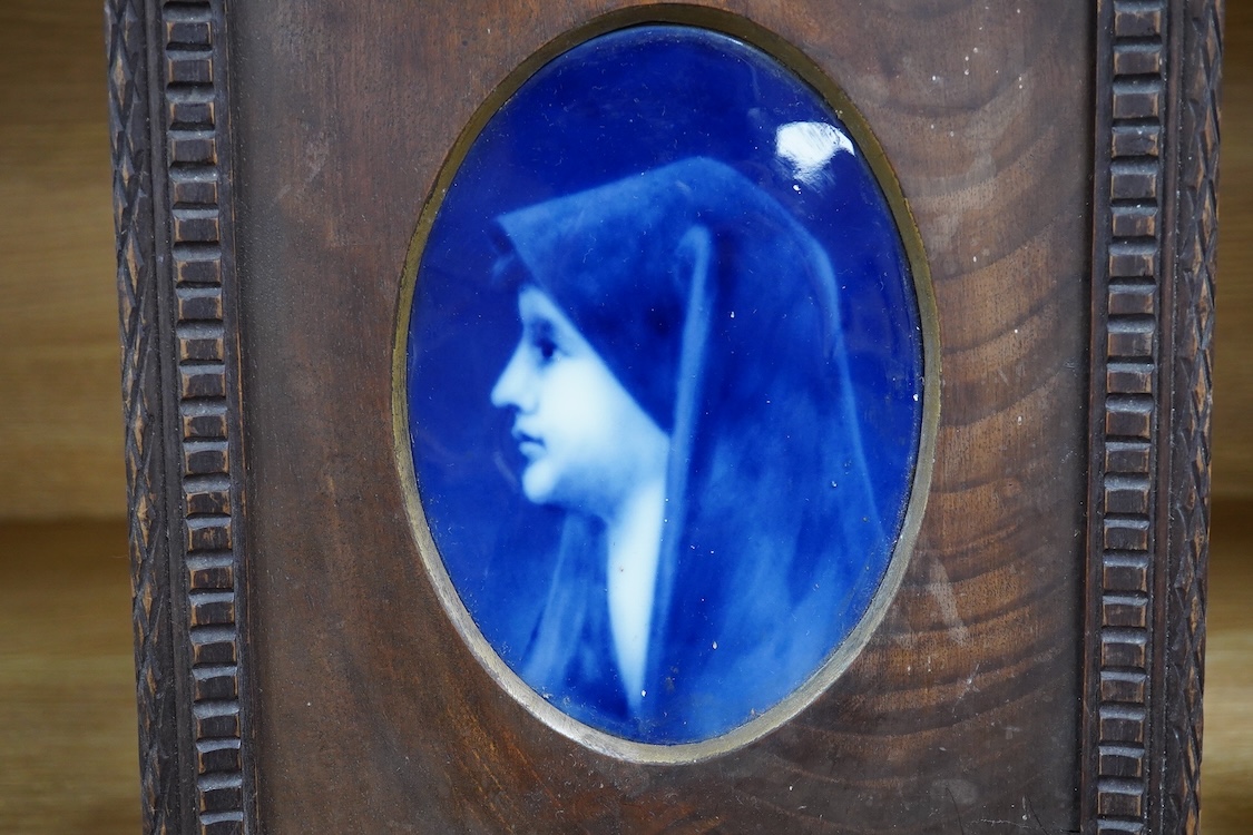 A Limoges plaque depicting a portrait of Saint Fabiola after Jean-Jacques Henner, framed, 29cm high